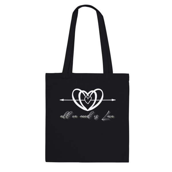713de905-7f55-4d5d-b92a-f75d45eae9e0.jpg Black tote bag with the All We Need is Love heart and script design