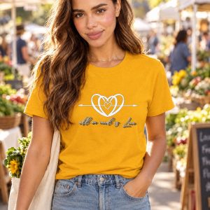 AI-generated model Maya wearing the golden-yellow All We Need is Love crewneck T-shirt at a farmers market