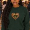 AI-generated model Nia wearing the Forest Green Be Drunk with Love crewneck sweatshirt at an autumn street festival